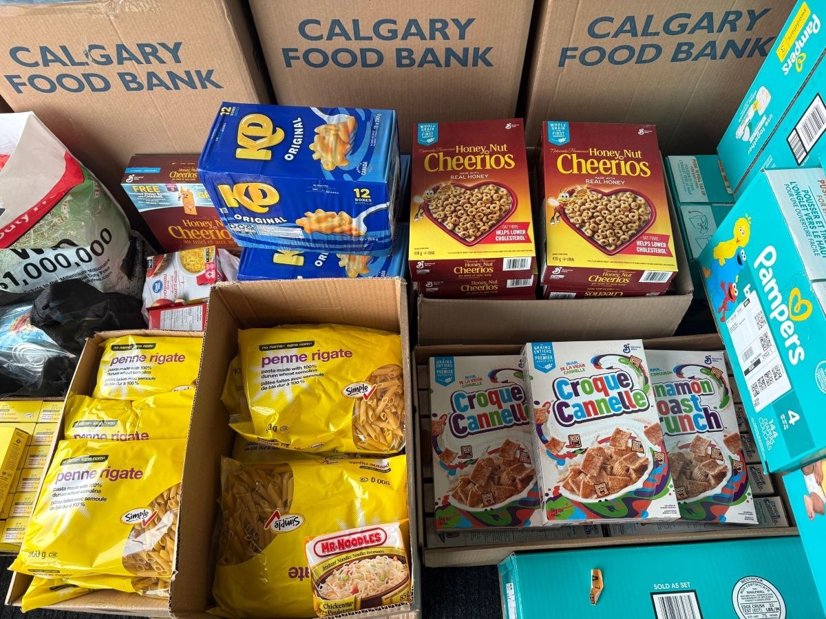 Boxes of various foods including dry breakfast cereals and packages of pasta.