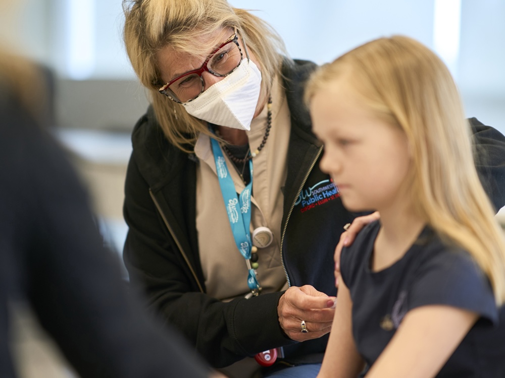 Public health nurse Lauri Bidinot demonstrates how to give a measles shot to a young girl at Southwestern Public Health in St. Thomas, Ontario.