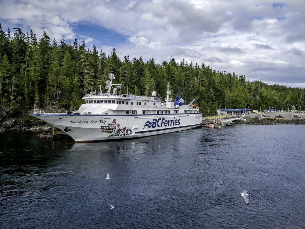 A white BC Ferries ship named ‘Northern Sea Wolf’ is docked in coastal British Columbia.