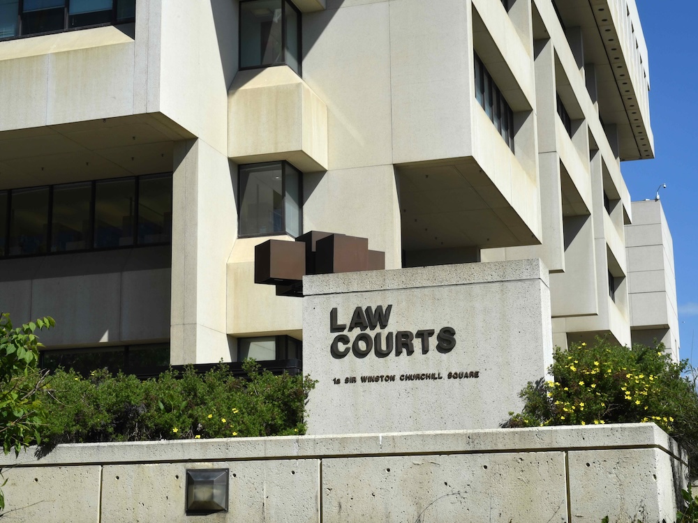 An image of a concrete building with a sign saying &lsquo;Law Courts.&rsquo;