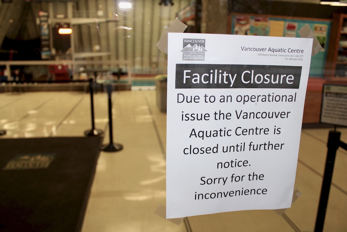 A sign taped to the glass window of an aquatic centre reads, &lsquo;Facility Closure. Due to an operational issue the Vancouver Aquatic Centre is closed until further notice. Sorry for the inconvenience.&rsquo;