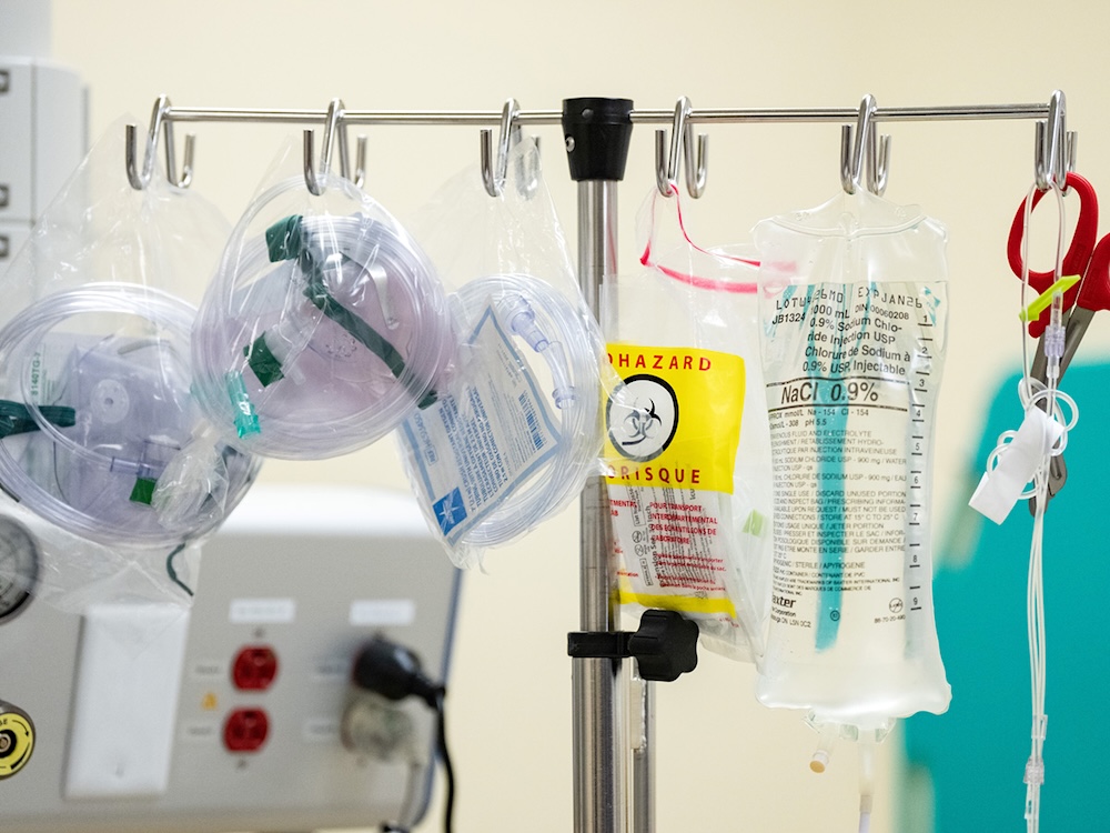 An IV pole and related equipment in a hospital room.