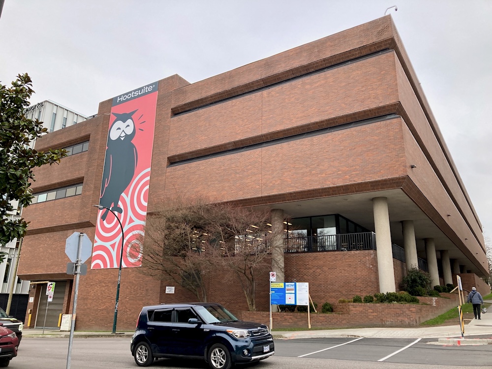 A brick office building with a mural of an owl.