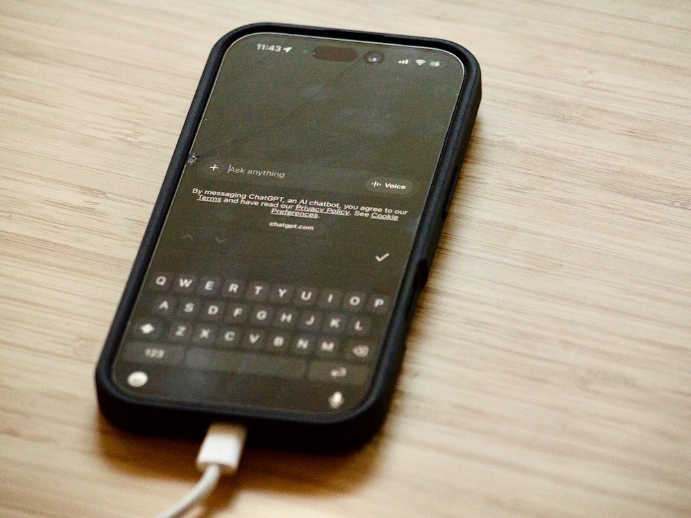 A phone sitting on a table shows text from ChatGPT.