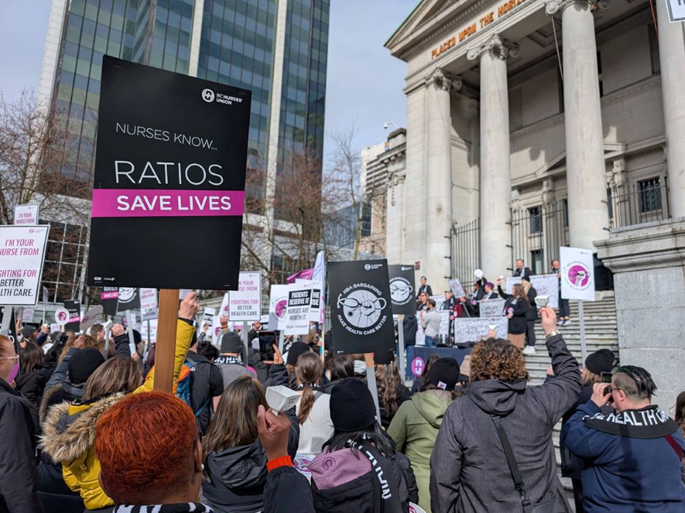 Nurses rally outside the Vancouver Art Gallery. A sign in the foreground reads, &ldquo;Nurses know&hellip; ratios save lives.&rdquo;