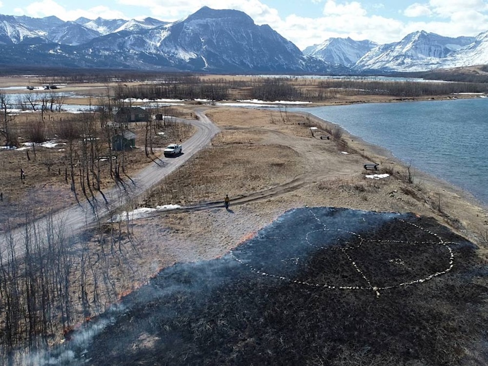 An aerial view shows a cultural burn in progress in Waterton national park in Alberta.