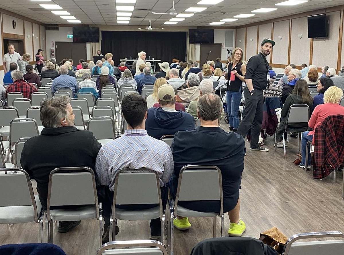 A room full of people in a small town community hall. 