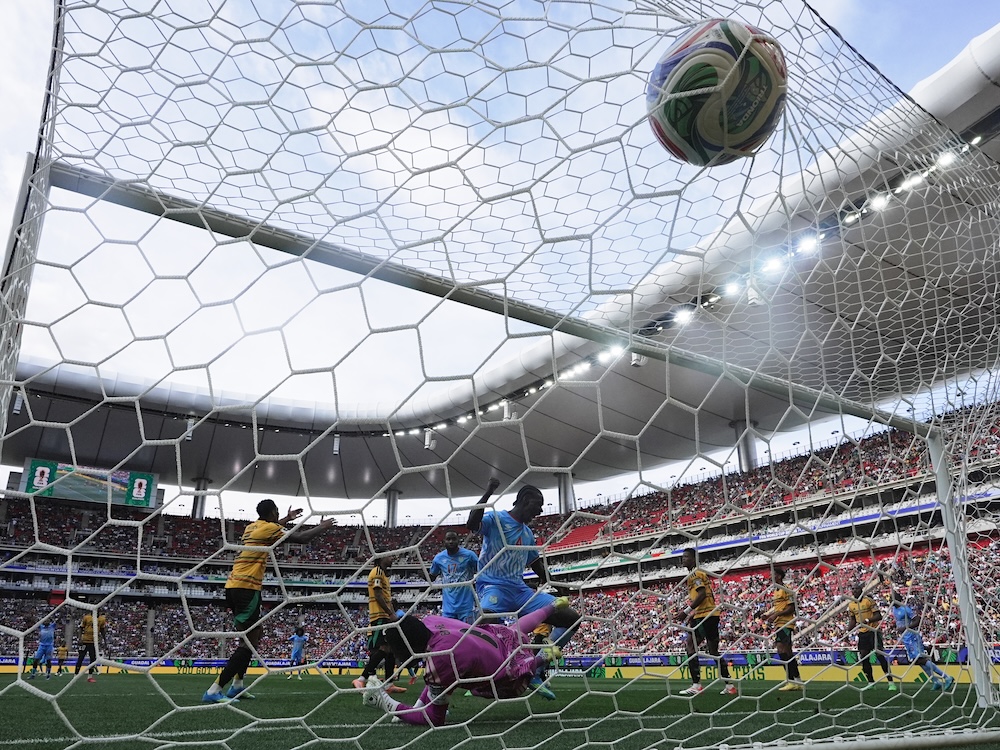 A view of a World Cup soccer match goal from behind the net.