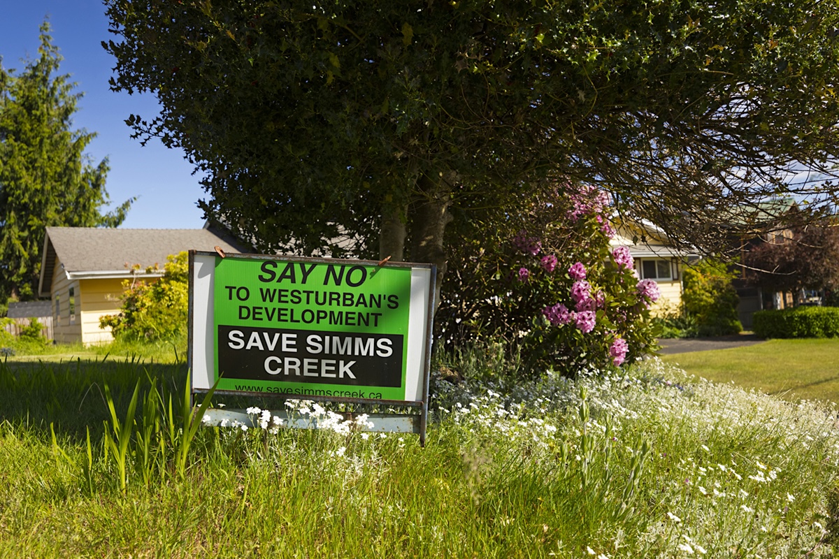 A lawn sign reads, &lsquo;Say No to WestUrban&rsquo;s Development. Save Simms Creek.&rsquo;