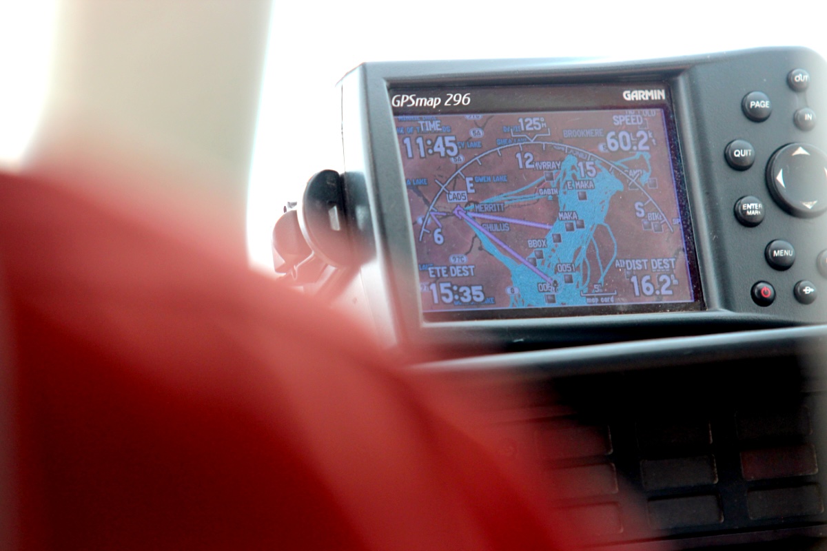 A digital GPS map device shows blue lines, representing helicopter traffic, atop a map of the area.