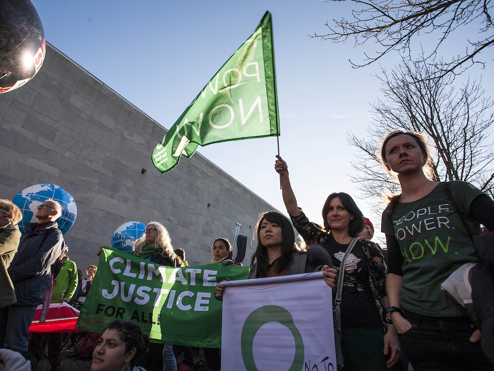 A group of protesters, most of them young, with signs and flags urging action on the climate crisis.