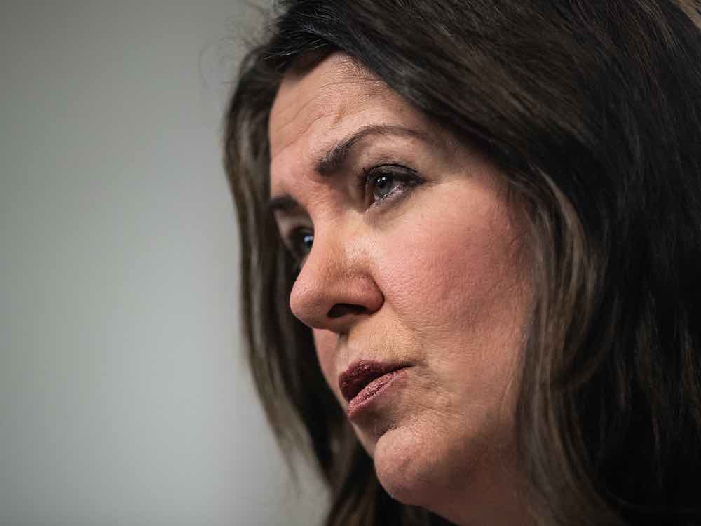 A side angle close-up of A 52-year-old white woman with shoulder-length dark hair.