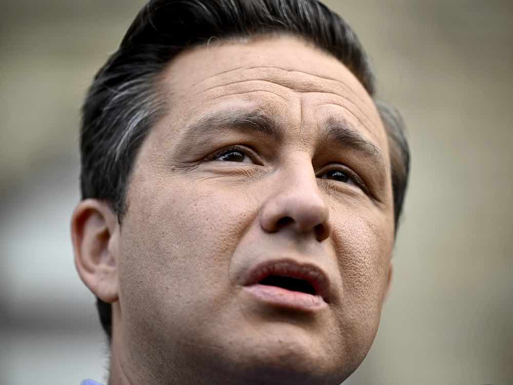 A 44-year-old white man with dark hair grey at the temples is photographed in close-up, mouth slightly open.
