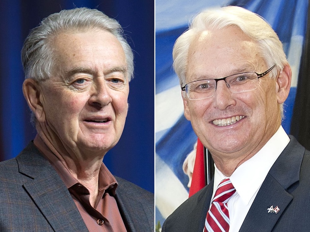 On the left is Preston Manning, a man in his 80s with silver hair, wearing a suit. On the right is Gordon Manning, a man in his 70s with white hair and glasses, also wearing a suit.