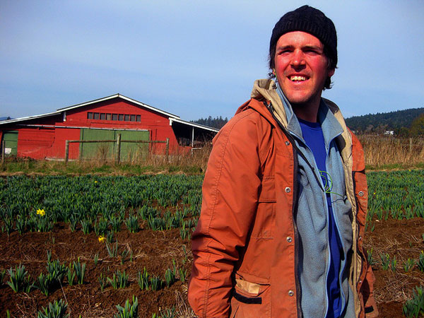 Flower farmer in field in front of barn