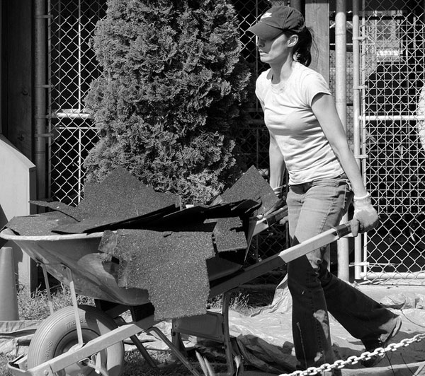 Woman pushing wheelbarrow