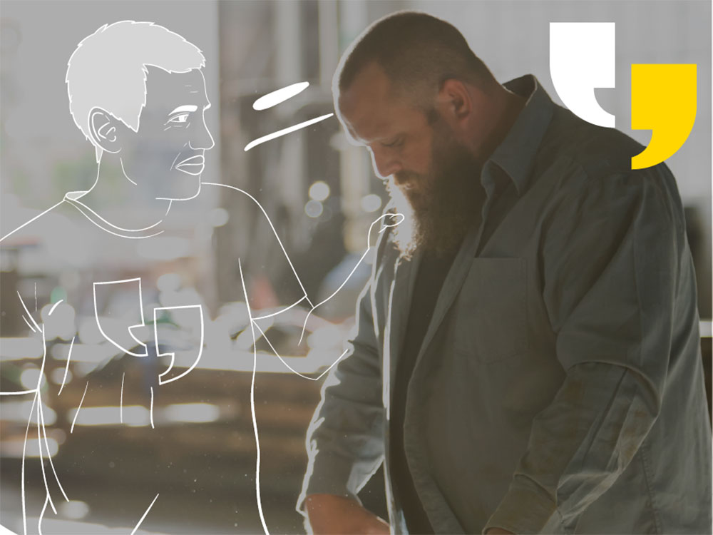 Outline of man consoling a tradesperson at work. The tradesperson is looking down, sombre, while measuring a piece of sheet metal.