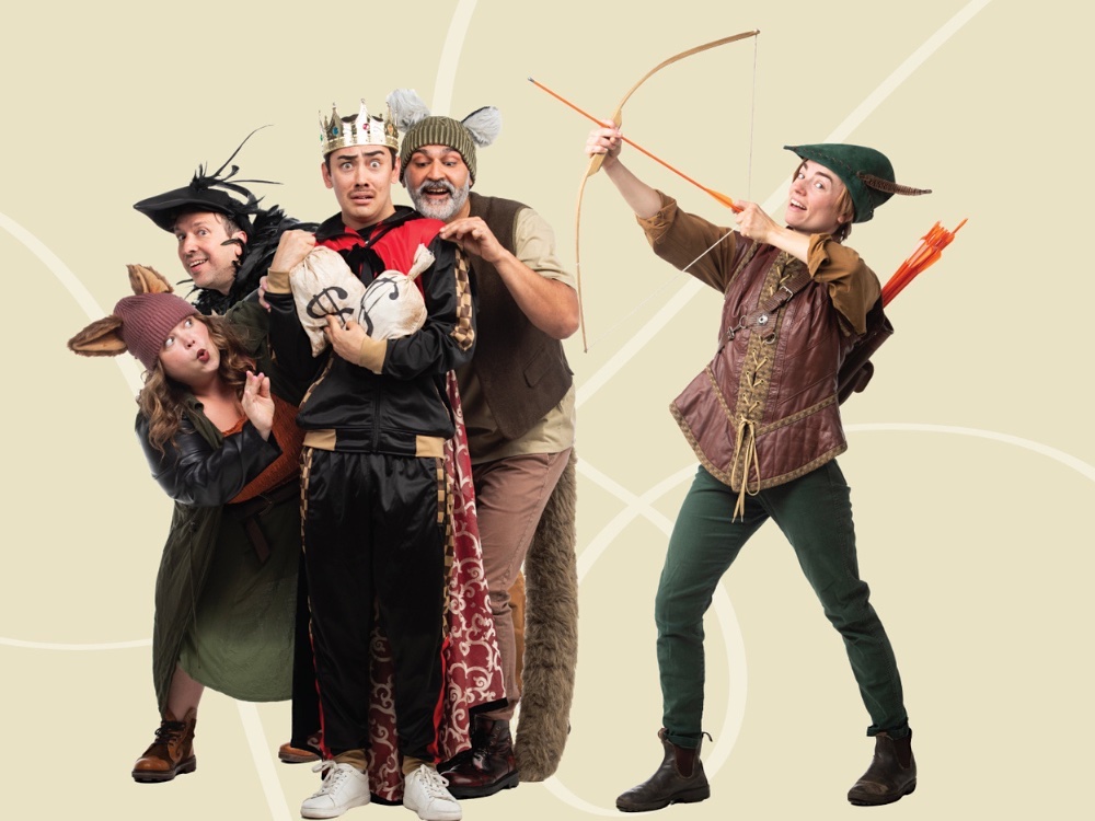 Five people stand on a stage, posing expressively in Robin Hood costumes.