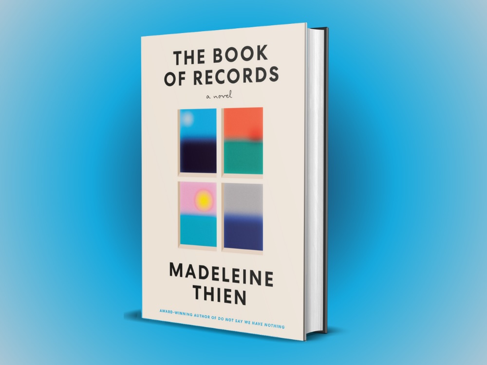 The novel’s cover, which features four windows that look out onto soft contrasting colours, is set against a sky-blue background.