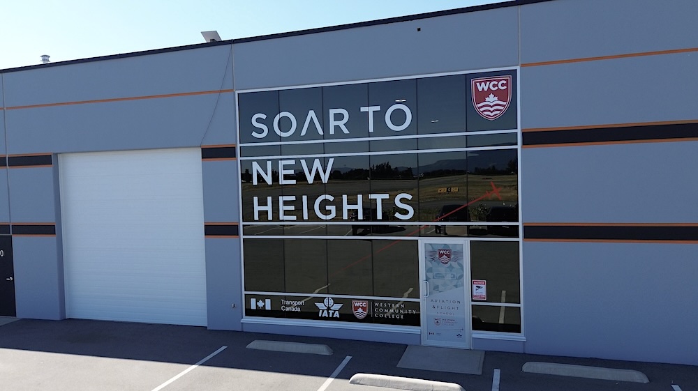 The WCC aviation and flight school, with reflective windows that read, &lsquo;Soar to new heights.&rsquo;