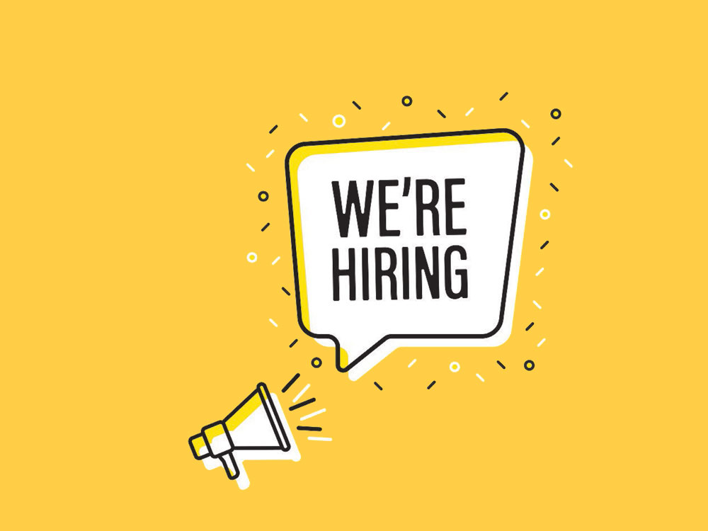 A clip art megaphone points to a cartoon speech bubble that reads &lsquo;We&rsquo;re Hiring&rsquo; on a deep yellow background.
